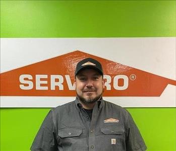 Man standing in front of green SERVPRO background.
