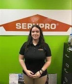 woman standing in front of door in SERVPRO shirt