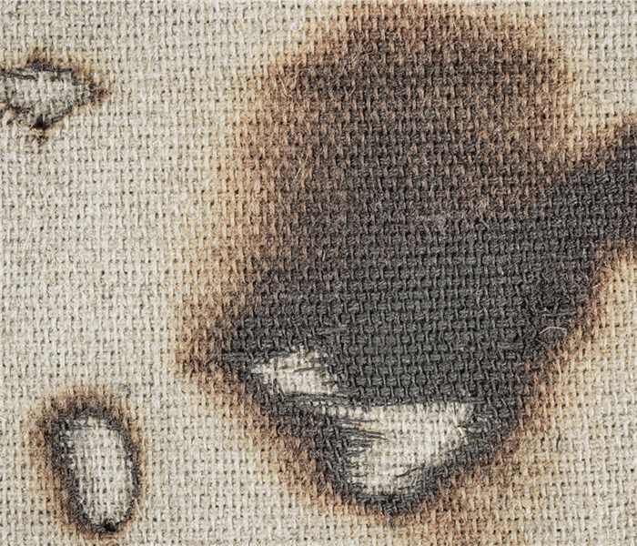 Burn marks on fabric.